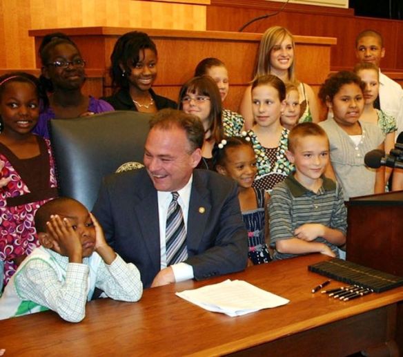 A politician surrounded by many childrens. Intellectual equals.