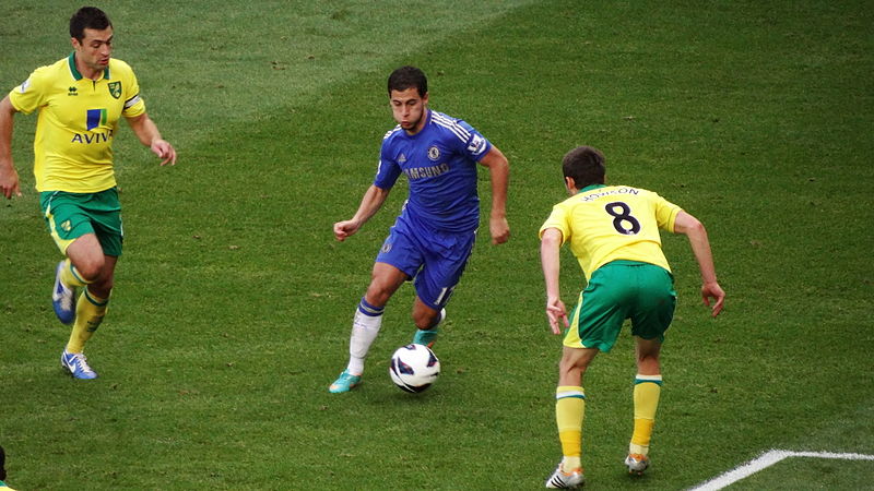Eden Hazard taking on Norwich defenders, while storing nuts in his cheeks.